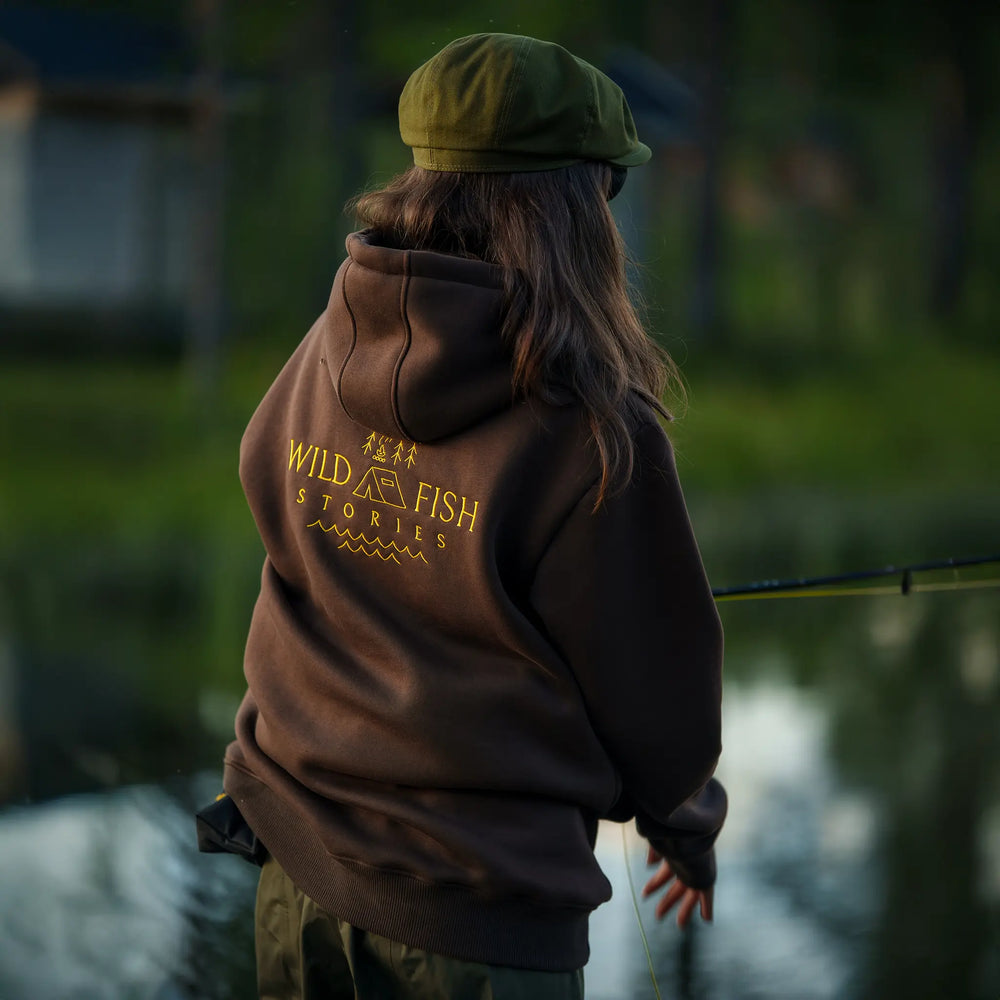 Bluza wędkarska Wild Fish Stories z dużym logo na plecach noszona podczas łowienia nad wodą, outdoorowy styl życia