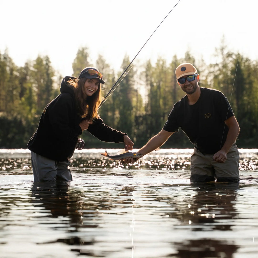 T-shirt El Clasico Wild Fish Stories - para wędkarzy w czarnych t-shirtach z rybą nad rzeką fly fishing